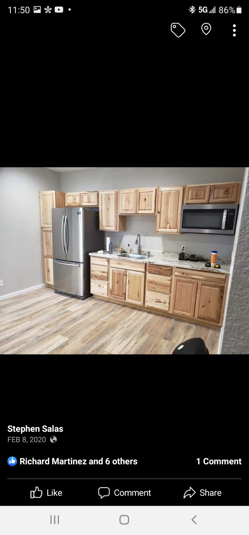 Kitchen project with natural wood cabinets and plank flooring