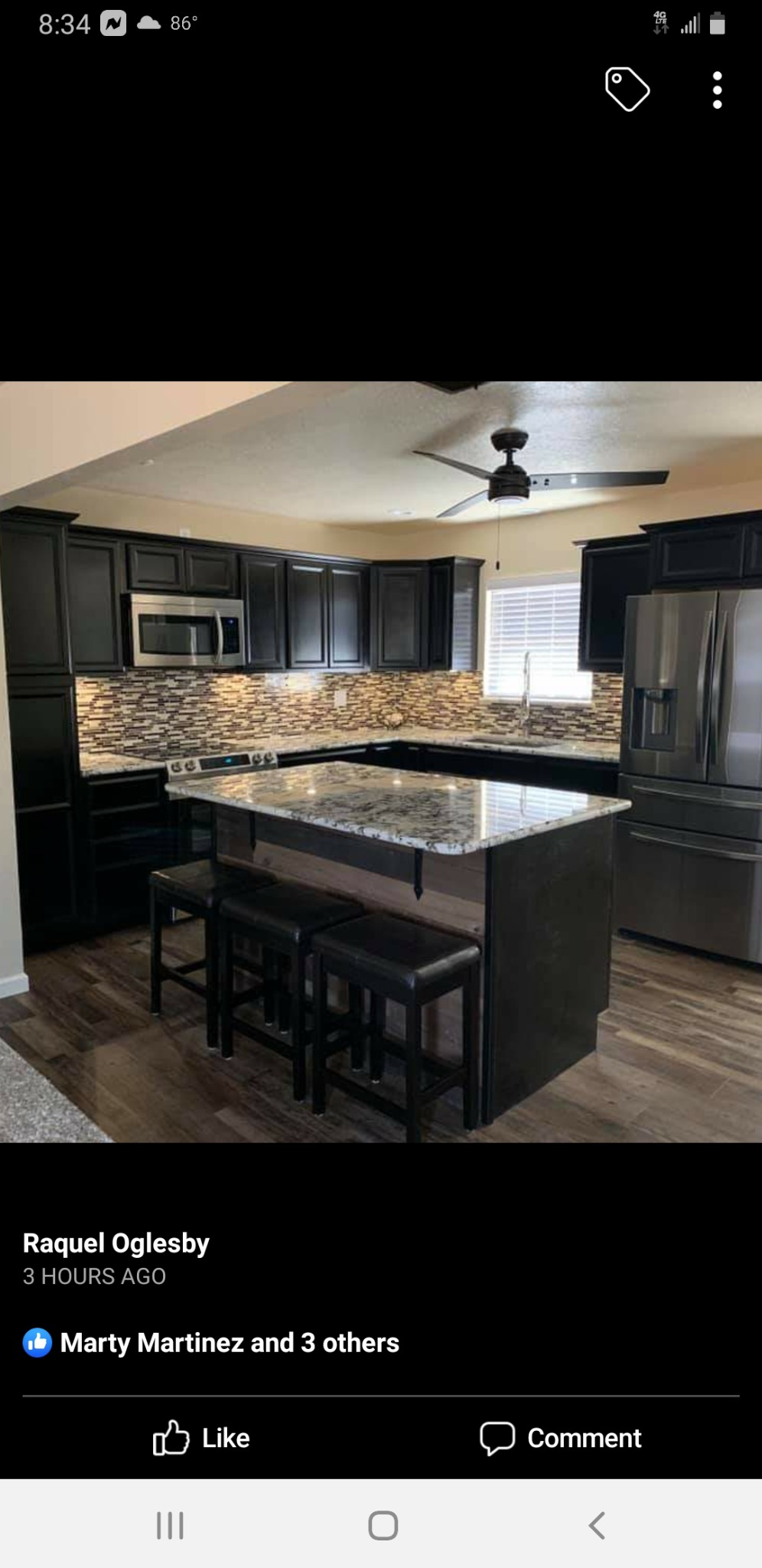 Kitchen with dark cabinets, mosaic backsplash and a stone countertop island